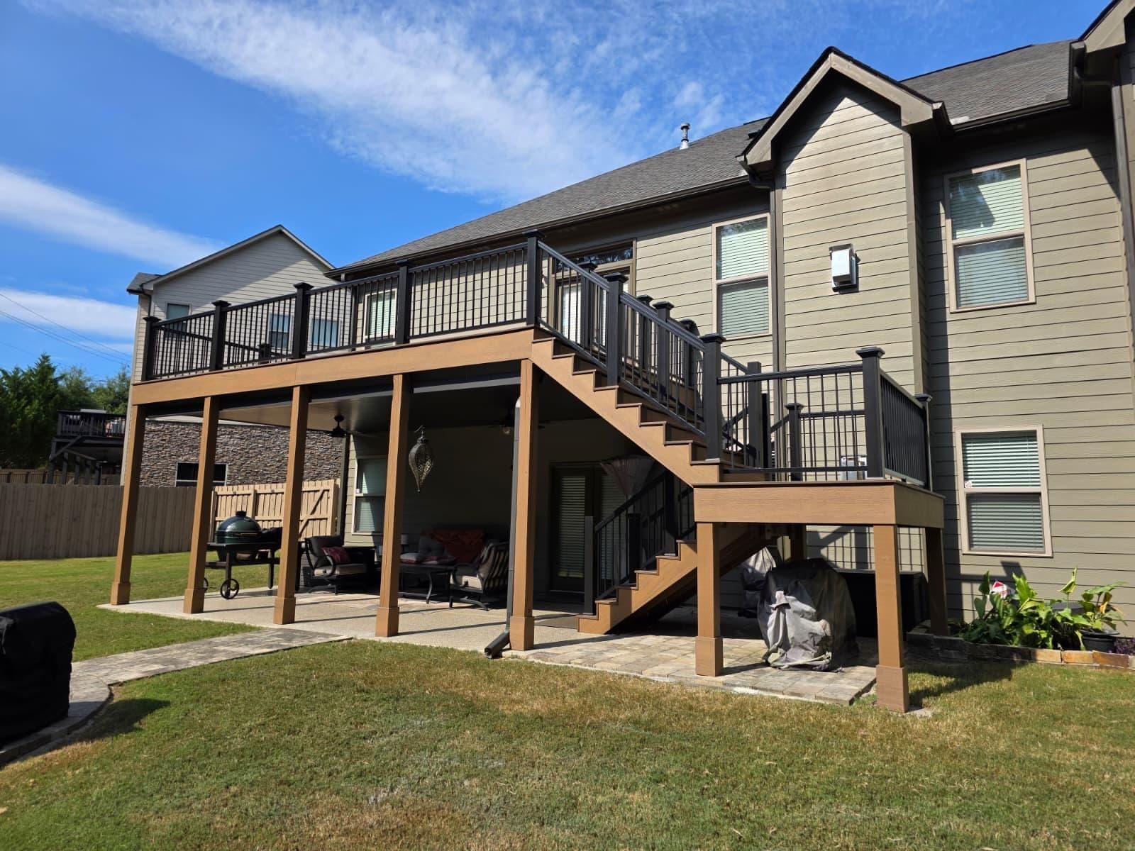Elevated composite deck with black aluminum railings and covered patio below, Metro Atlanta