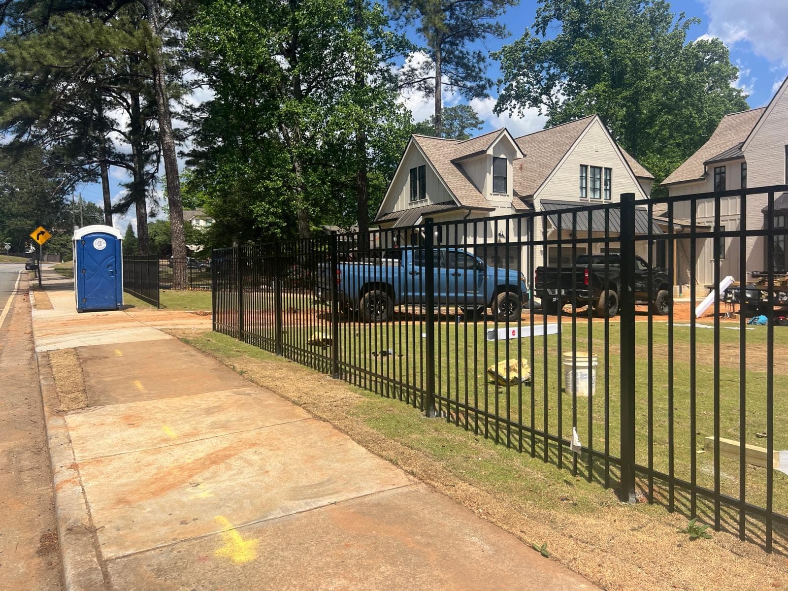 Black ornamental metal picket fence along a street frontage in Metro Atlanta