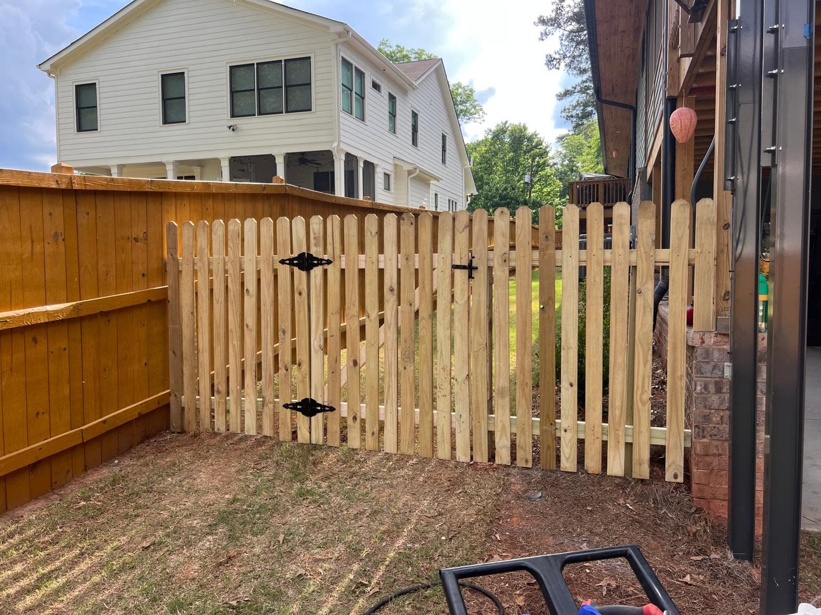 Spaced picket wood fence and matching gate in a Metro Atlanta backyard
