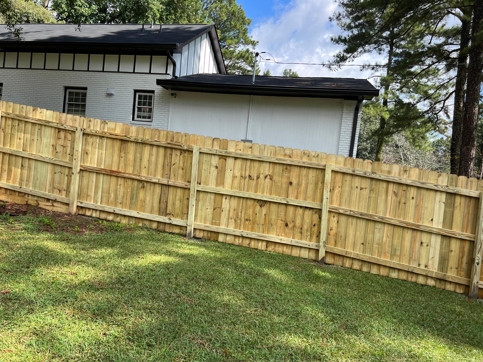 Repaired wood fence with reset posts in Metro Atlanta